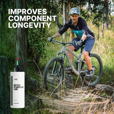 Biker on a trail using Fork Stanchion And Shock Lube For Bikes Keeps Suspension Smooth Like Butter Reducing Stiction, Blocking Rust