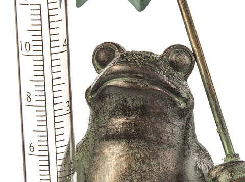 Close-up of Garden Frog Statue With Umbrella Glass Rain Gauge Weather Station for Outdoor Decor, showing rain gauge scale.
