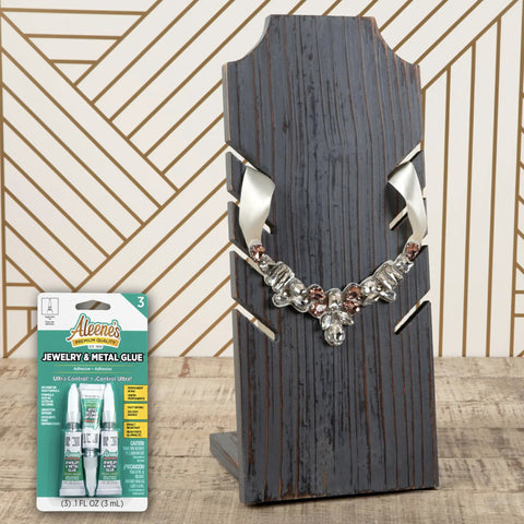Jewelry And Metal Glue Three Pack 0.1 Oz Instant Adhesive For Jewelry Making And Repairs Waterproof Dries Clear next to a necklace.
