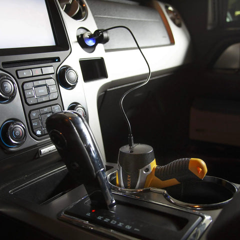Rechargeable 1000 Lumen 5W LED Spotlight Flashlight With Micro USB Charging in vehicle cup holder, dashboard view