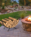 Beefy Heavy Duty Curved Firewood Rack 33 Inch Steel Log Holder by a fire pit in a backyard setting
