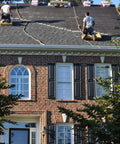 Two roofers using Heavy Duty Roofing Cushion With Killer Traction And Heat Blocking Kneeler Mat on steep shingle roof.