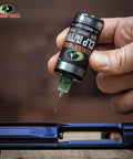 Applying Mossy Oak All In One Gun Cleaning Oil CLP For Firearms Clean Lubricate And Protect In One Step with needle oiler
