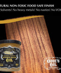 Jar of Odie's Oil Industrial Strength Butcher Block Oil beside treated wood surface, ideal for cutting boards and countertops.