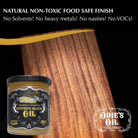 Jar of Odie's Oil Industrial Strength Butcher Block Oil beside treated wood surface, ideal for cutting boards and countertops.