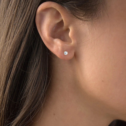 Woman wearing Solid 14K Yellow Gold 5mm Round Cubic Zirconia Solitaire Stud Earrings With Secure Ball Screw Backs For Women Hypoallergenic Everyday Wear