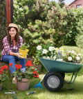 Gardener beside Two Wheel Garden Wheelbarrow Cart With Built In Stand For Home Yard Work, carrying flowers, plants on lawn.
