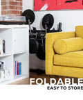 Compact Turbo Mesh Kit Electric Drum Set with 100 Plus Sounds stored neatly beside yellow sofa