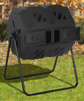 Dual Chamber Compost Bin With 43 Gallon Capacity Rotating Tumbler For Fast Easy Composting Sliding Doors For Grab And Go Convenience Great For Garden Kitchen And Yard Outdoor Black shown outdoors in garden.