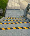 Anti Slip Grip Tape 2 Inch By 60 Foot High Traction Non Skid Tape on outdoor stone stairs with yellow and black caution pattern