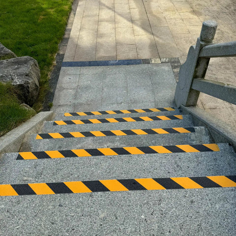 Anti Slip Grip Tape 2 Inch By 60 Foot High Traction Non Skid Tape on outdoor stone stairs with yellow and black caution pattern