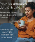 A woman holding a coffee cup wearing an orange sweater, showcasing the importance of 12 Pack Replacement Water Filter Cartridges For Coffee Machines And Kettles Kick Limescale To The Curb Strip Chlorine For Crisp Better Tasting Brews Anytime Smooth Installation Top Shelf Appliance Defense.