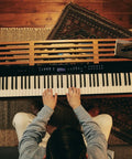 Px-S3100 88 Key Weighted Digital Piano With Bluetooth Audio MIDI on wooden stand, player seated, seen from above