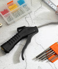 Air Nozzle Blower Gun With Pro Grade Pistol Grip Set For Compressors on a workbench with tools.