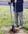 Person using Post Hole Digger With 48 Inch Fiberglass Handle, Atlas Pattern Steel Point For Easy Holes in a grassy garden area.