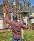 Man using Extendable Handles Compound Action Bypass Lopper For Thick Branches Up To One And A Half Inches in garden