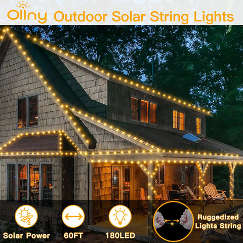 Solar Outdoor String Lights 60Ft 180 LED IP67 Waterproof Dope 8 Modes With Timer Memory Function decorating a house at night.