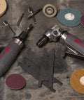 5102MAX Air Die Grinder with Right Angle Head shown with accessories and discs on a workshop surface.
