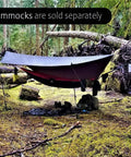 Waterproof Hammock Rain Fly Hex Tarp 12 By 9 Feet over hammock in forest, premium lightweight ripstop nylon provides shelter.