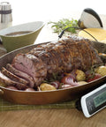 Roast lamb with potatoes next to Stainless Steel Salt And Pepper Grinder Set For Kitchen And Table Easy Refill; thermometer reads 135F