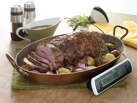 Roast lamb with potatoes next to Stainless Steel Salt And Pepper Grinder Set For Kitchen And Table Easy Refill; thermometer reads 135F
