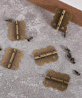 Bronze Antique Mini Hinges For Wooden Boxes 30 Piece Set With Screws 25x20mm Tiny Folding Butt Hinges assorted on surface