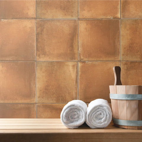 Rustic Cotto 13x13 Porcelain Tile For Floor And Wall, Glazed Textured Finish, shown as wall backdrop with rolled towels and bucket.