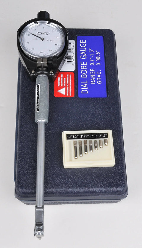 Front view of Fowler dial bore gauge set, 0.7–1.5 in range, dial indicator, blue case label, and nine rods.