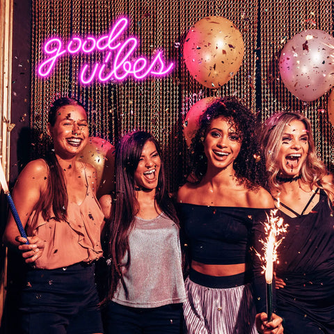 Group of friends celebrating under Pink Good Vibes Neon Sign For Bedroom And Wall Decor, LED Neon Lights For Living Room Or Office