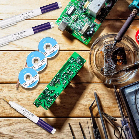 Soldering Pen And Solder Wick Kit For Electronics Repair with 3 pens and 3 wick strips shown on a wooden table.