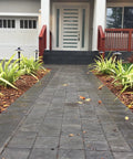 Aluminum Low Voltage Landscape Path And Area Light Kit with 6.5 inch shade and black finish along a stone path in garden