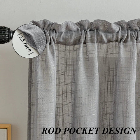 Close-up of a gray linen textured swag curtain valance with rod pocket showing 2.5-inch header.