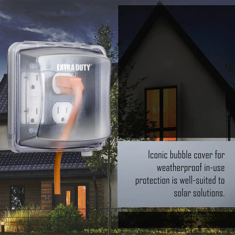 Extra Duty Weatherproof In-Use 2-Gang Electrical Outlet Cover For Outdoor Use Nonmetallic Clear 2.75-Inch Opening Wet And Damp Location Rated Easy Install Heavy-Duty Protection For Home Improvement Projects mounted on house exterior at night.