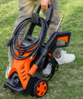 Person carrying Electric Pressure Washer 2300 PSI 1.6 GPM Portable Power Washer with Adjustable Spray Nozzle on grass