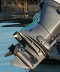 Outboard engine with Dual Water Feed Boat Motor Flusher with Rectangular Cup Muffs and Hose Fittings Flush Kit attached.