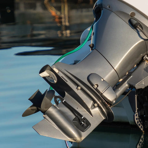 Outboard engine with Dual Water Feed Boat Motor Flusher with Rectangular Cup Muffs and Hose Fittings Flush Kit attached.