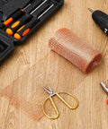Two Rolls Of 8 By 32 Ft Copper Mesh For Rodent And Pest Control with tools on wooden surface