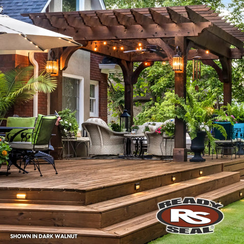 Top Shelf Dark Walnut Exterior Wood Stain and Sealer Turbo Spray System on a stylish wooden deck with seating area.