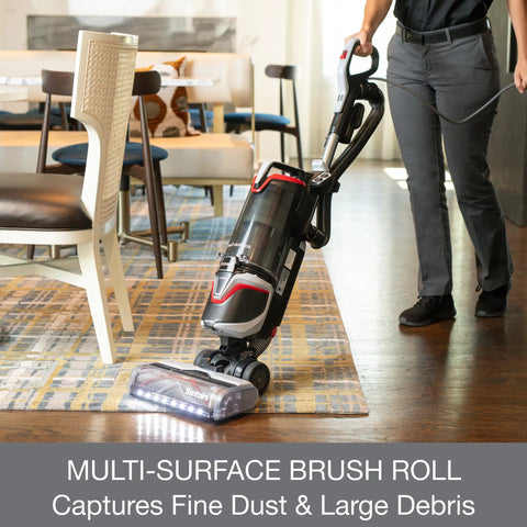 Commercial Grade Upright Vacuum Featuring Adaptive Surface Sensing Automation Alongside Long Lasting Motors in a dining room.
