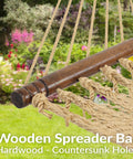Wooden spreader bar on cozy outdoor double hammock with soft spun polyester rope for extra support.