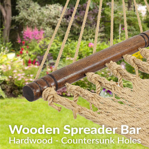 Wooden spreader bar on cozy outdoor double hammock with soft spun polyester rope for extra support.