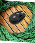 Kayak Anchor Trolley Kit With Nylon Single Sheave Blocks for smooth anchor adjustments on green rope and wood surface.