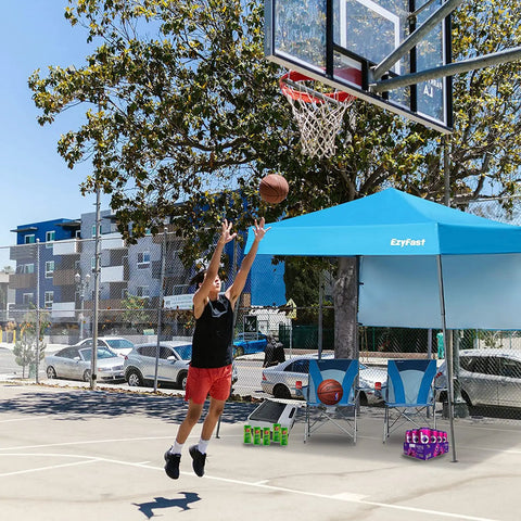 Grab-And-Go Ultra Compact Backpack Canopy Pop Up Shelter For Outdoor Adventures set up by a basketball court