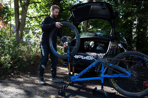 Man using Flipstand Compact Bike Stand With Tool Storage, Saddle Protector And Handlebar Stabilizers For All Bike Types.