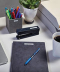 Grab And Go Portable Label Maker With Rechargeable Battery And Qwerty Keyboard Game Changing Handheld Printer For Office Organization on a desk with office supplies