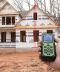 Pro Grade Laser Distance Meter 325 Ft is measuring a height on a construction site with a weatherproof build.