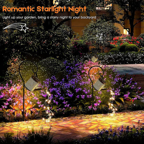 Solar Garden LED Light Watering Can Fairy Lights illuminate a colorful garden pathway with twinkling lights and a whimsical vibe at night