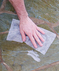 Hand wiping stone surface with Heavy Duty Cleaning Wipes For Every Surface And Hands, 90 Count, All Purpose Cleaner.