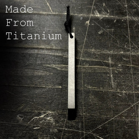 Ultra Lightweight Titanium Keychain Pry Bar With Minimalist Slim Design Everyday Carry Essential For Your Keys Ready For Quick Fixes On The Go Durable Aircraft Grade Titanium Built For Real World Tasks laying on a dark surface