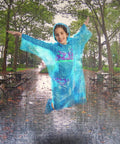 Child jumping in blue poncho in park, Extra Thick Rain Ponchos Family Pack With Shoe Covers Included 10 Pack For Rainy Days And Outdoor Adventures
